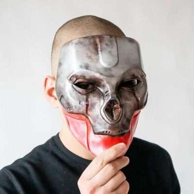 Guy holding a Revenants mask from Apex Legends