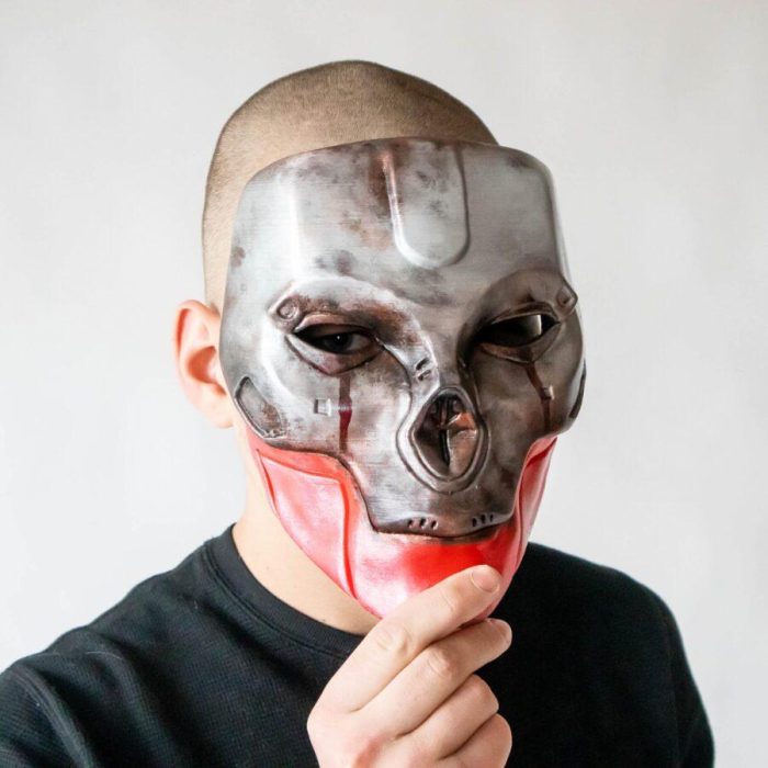 Guy holding a Revenants mask from Apex Legends